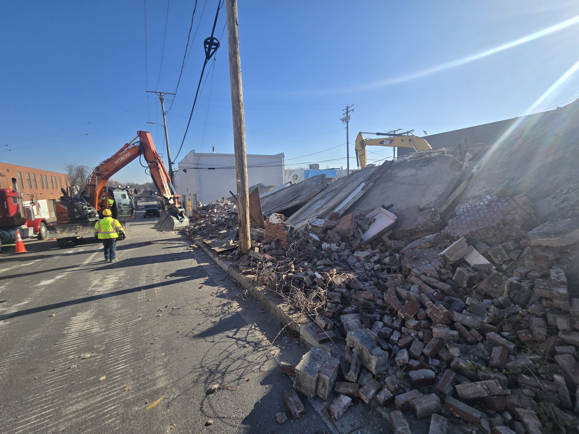 Excavators working a street-front commercial demolition site in Annapolis, MD