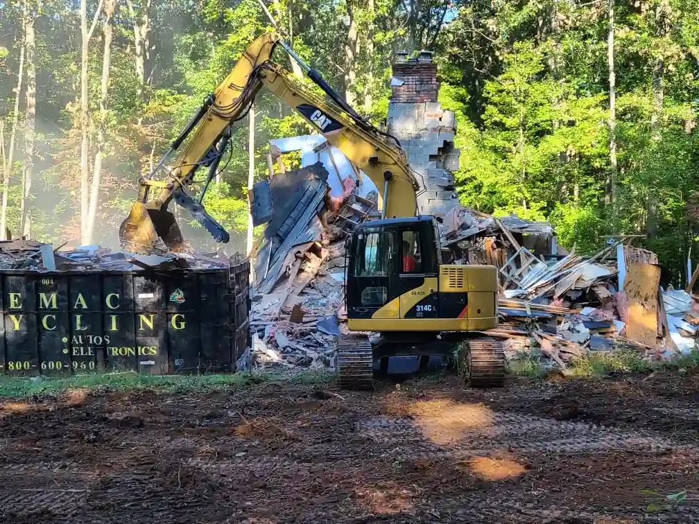 Excavator clearing debris from a residential teardown in Frederick, MD